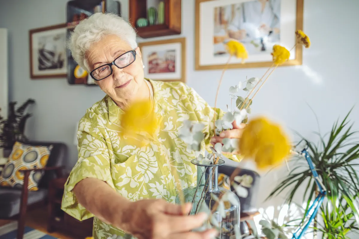 senior woman tending flowers